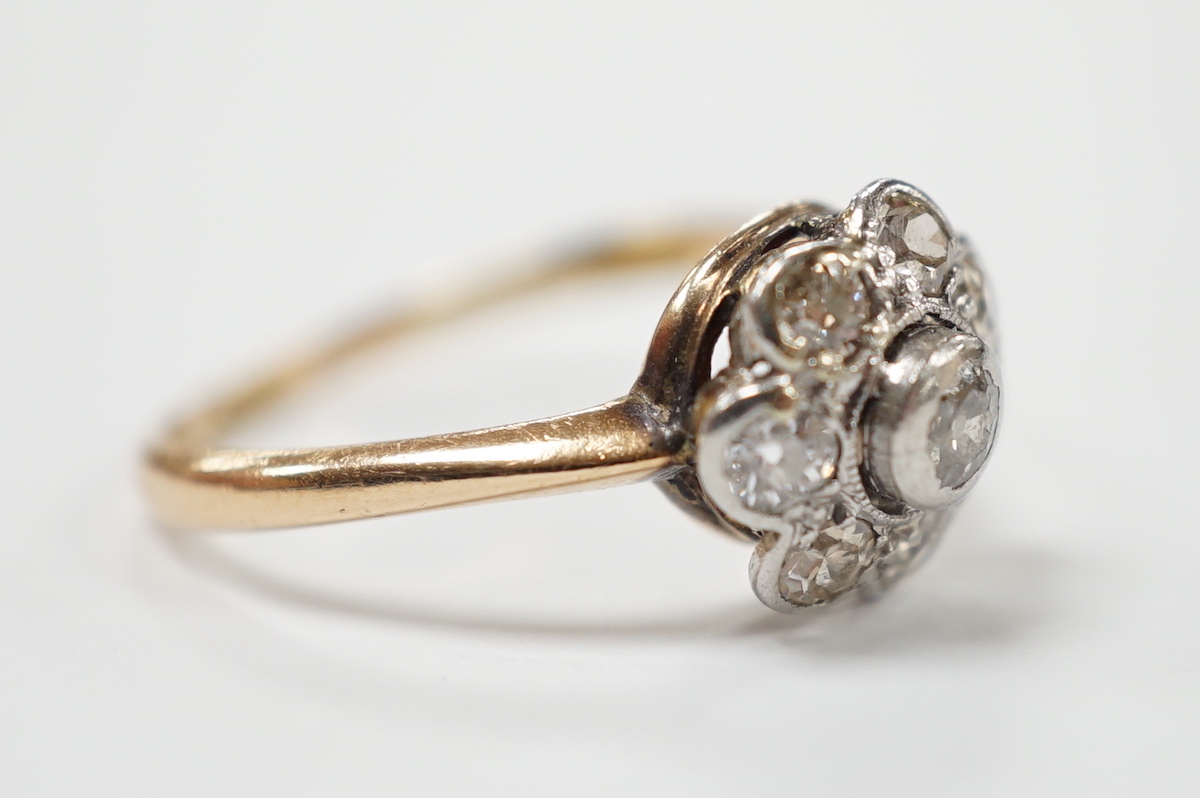 A yellow metal eight stone diamond cluster ring, size N